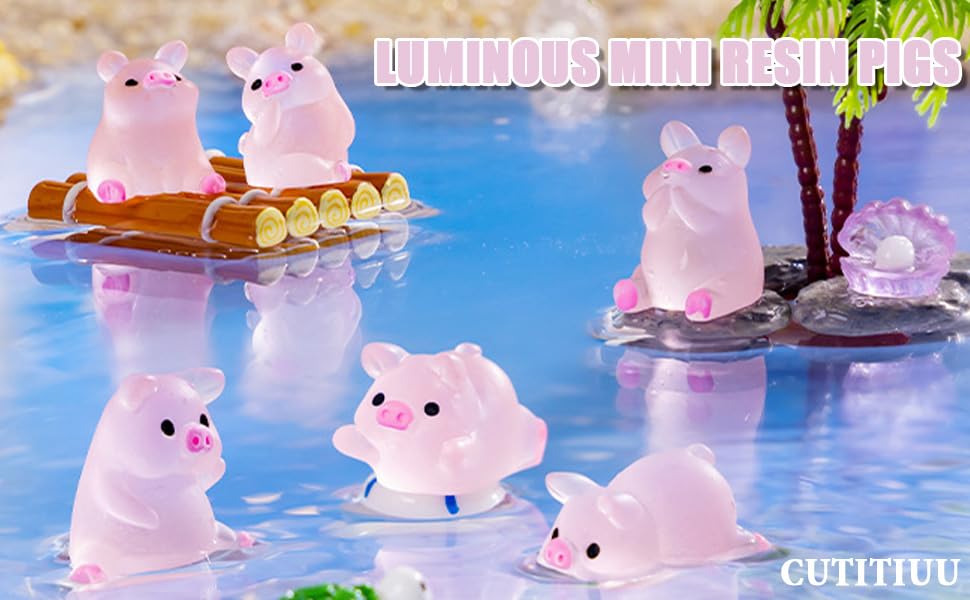 Small pink translucent pig-shaped figurines floating in blue water. Some on rafts, others on rocks. Text reads 'LUMINOUS MINI RESIN PIGS'.